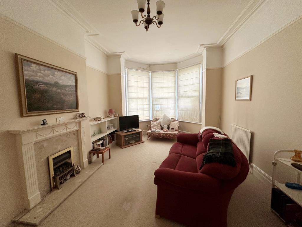 Lot: 74 - SUBSTANTIAL THREE-BEDROOM GARDEN FLAT FOR REFURBISHMENT - Living Room with fireplace and bay window